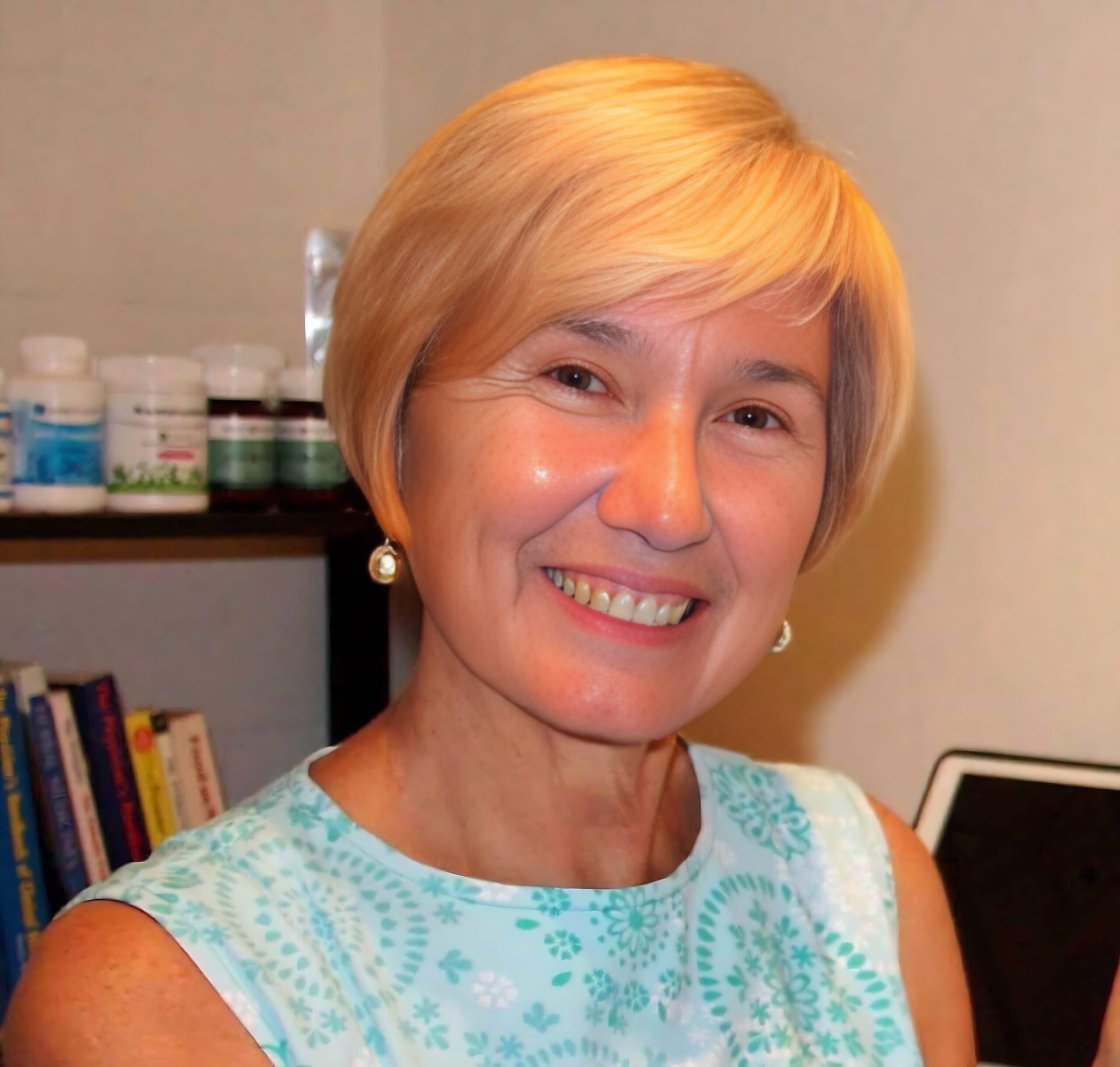 Shelly Smiling woman with short blonde hair.